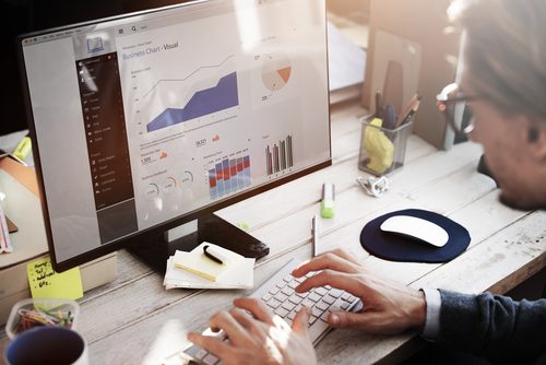 Introhive | Businessman Analyzing CRM Data 1 | The Knowledge Continuum: How Data, Information, and Intelligence Work Together
