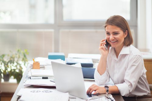 Woman talking on phone at office