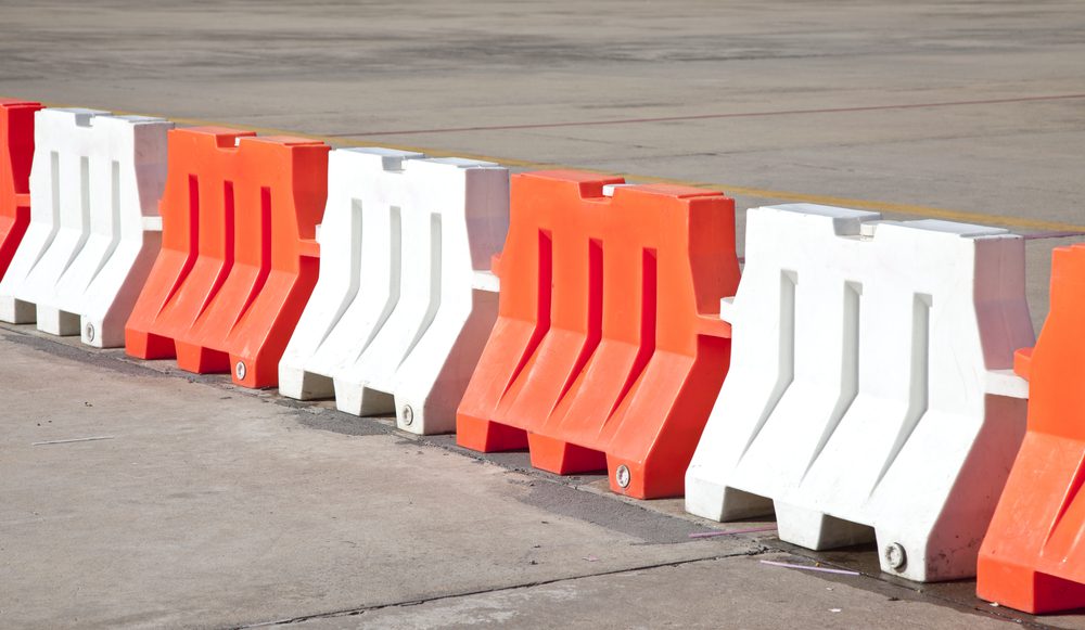 Red and white barriers blocking a road