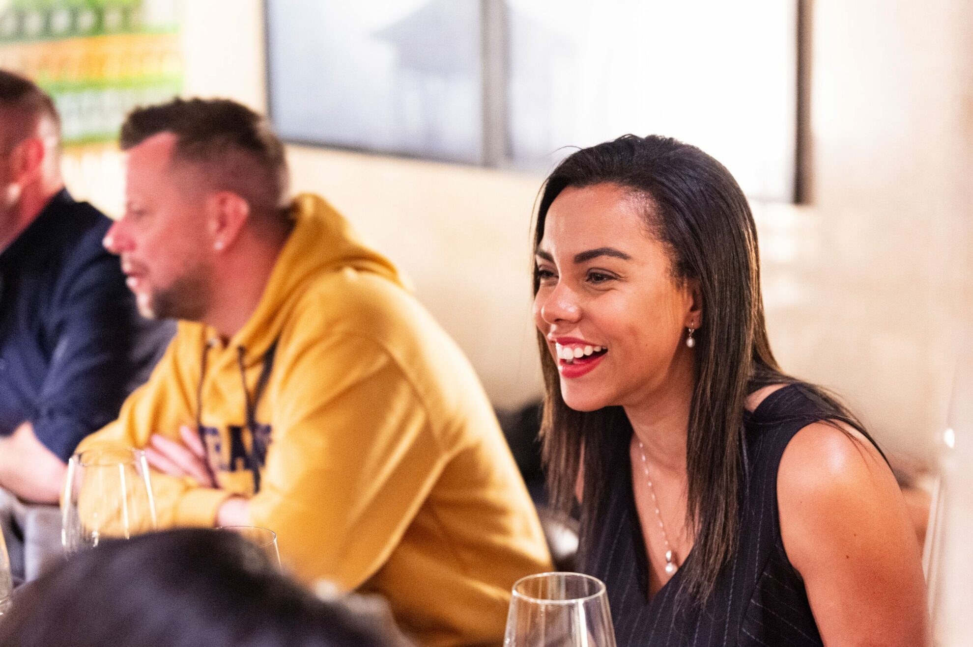 Woman smiling, drinking wine