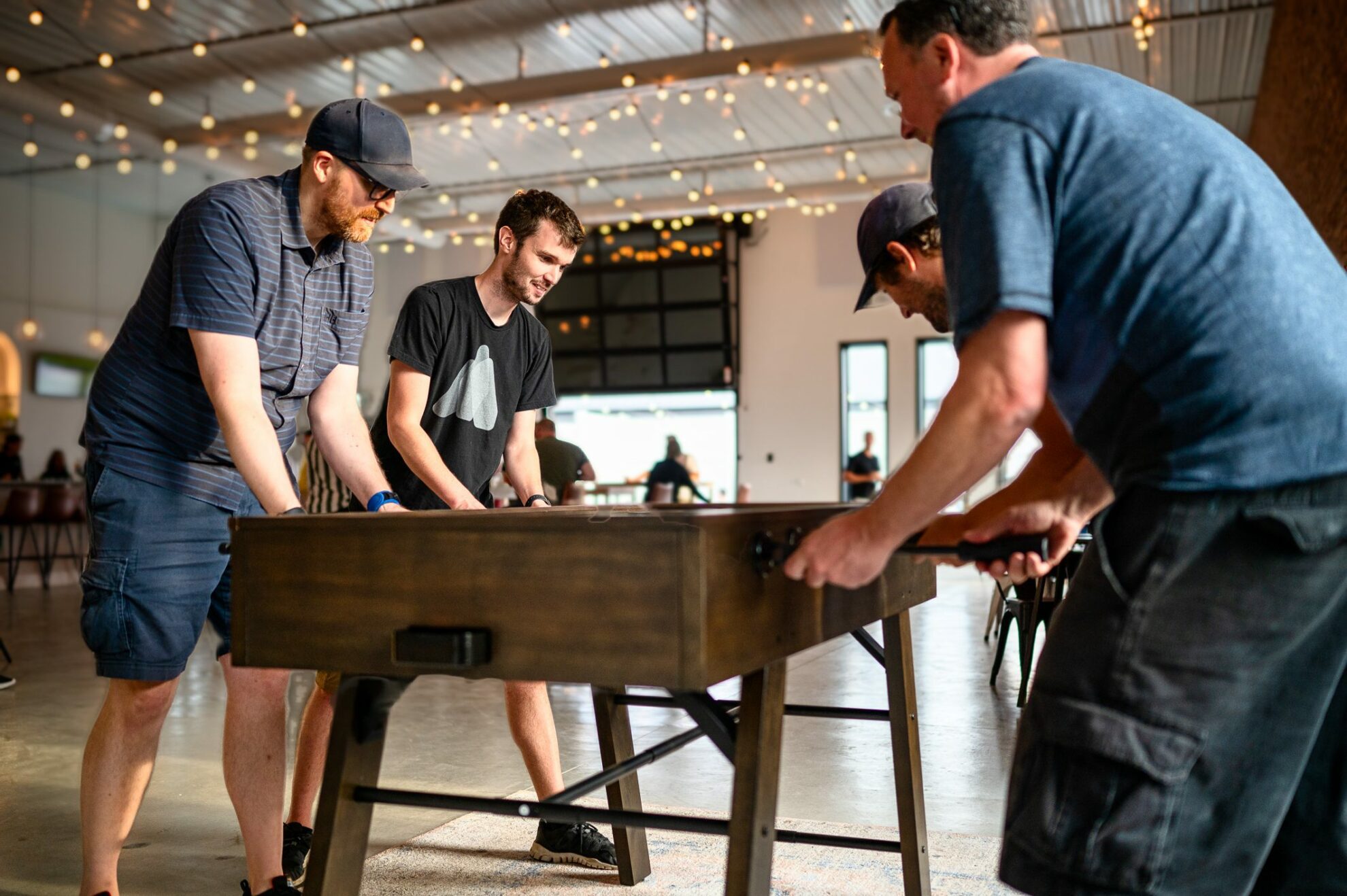 Introhive employees play foosball in the Fredericton office