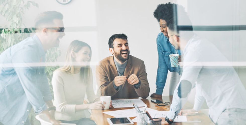 Team collaborating in a modern office, discussing CRM with marketing automation and the importance of ensuring data is continuously up-to-date with automation and data enrichment tools to drive smarter engagement.