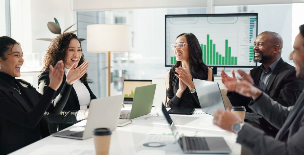 Business professionals recognizing success in post-merger synergy creation with data-driven results in the background