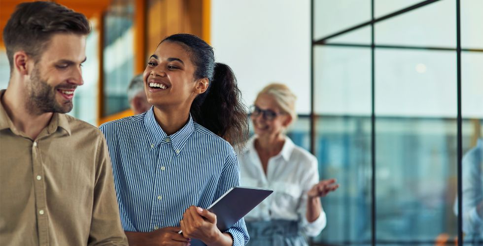 Business professionals discussing a potential warm introduction to a key stakeholder for an upcoming RFP, demonstrating how relationship intelligence maps ‘who knows who’ and provides actionable insights for better client outcomes.