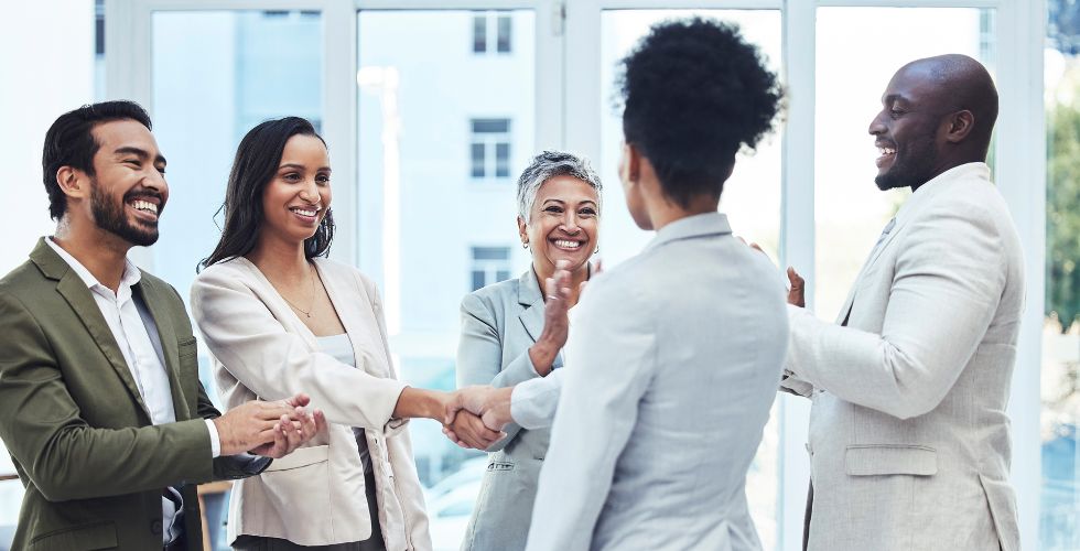 Team members after a meeting, showing the benefit of automated CRM data capture that eliminates manual updates.