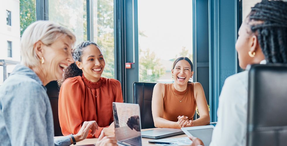 Business team collaborating and sharing ideas in a modern office setting — representing teamwork, data-driven decision making, and the importance of CRM best practices for 2026.