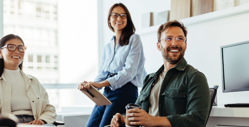 A professional services team informally discussing the differences between data, information, and knowledge as they look to analyze their client data and access insights that drive growth.