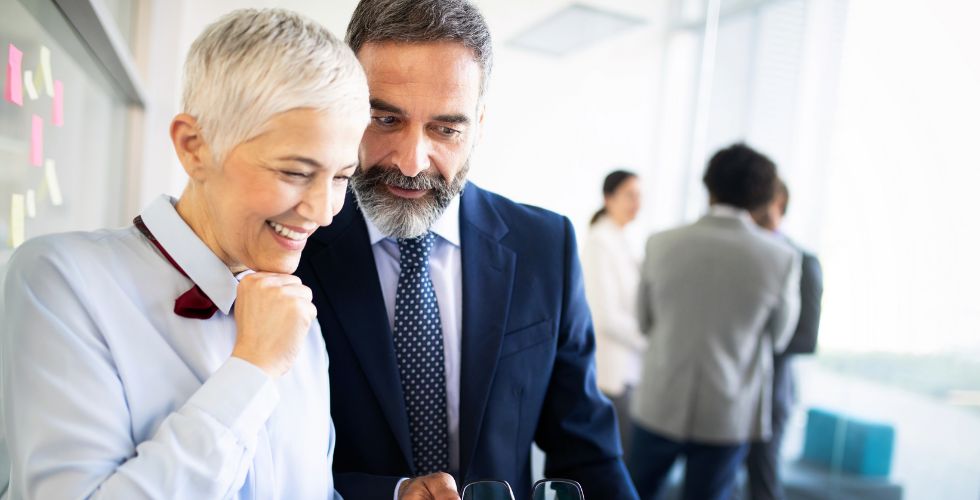 Business professionals discussing relationship-driven insights that weren’t accessible through traditional B2B sales intelligence, highlighting the shift from static data to real connection pathways.