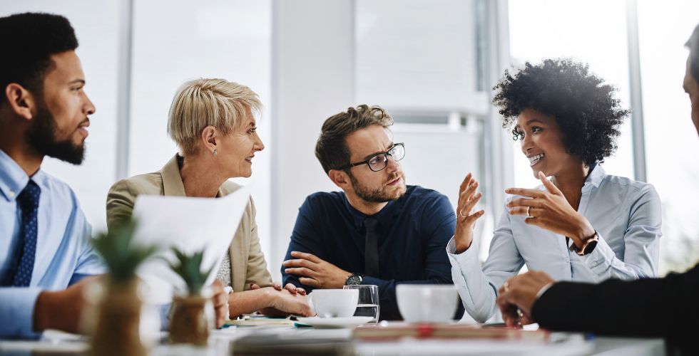 “A team of legal professionals in a collaborative meeting discussing client relationships and strategic insights, representing the missing layer of business intelligence for law firms.